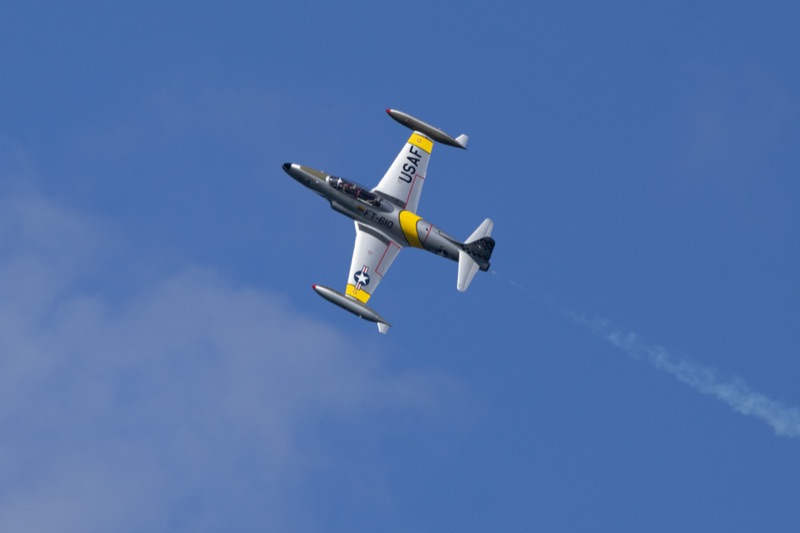 T-33 Shooting Star in flight, smoke trail behind